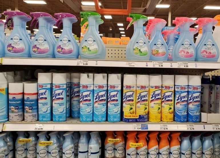 A shelf with many different cleaning products on it.