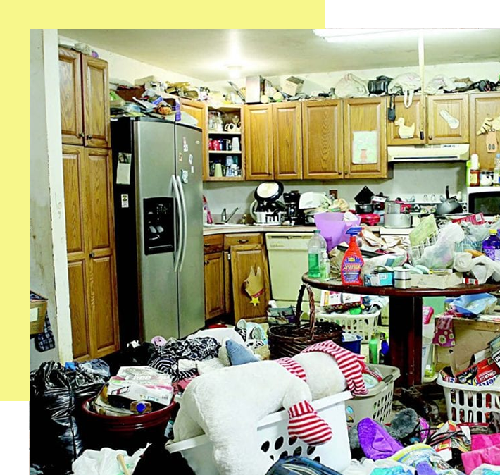 A cluttered kitchen with many items piled on top of each other.